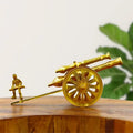 Brass canon with man showpiece statue